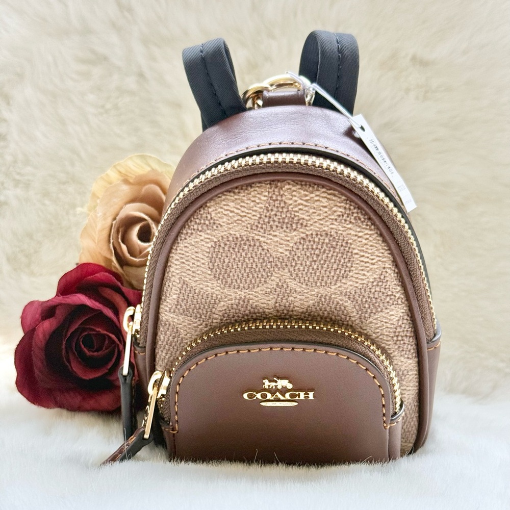 New with tags COACH Signature Mini Backpack BAG CHARM with outside zip pocket.